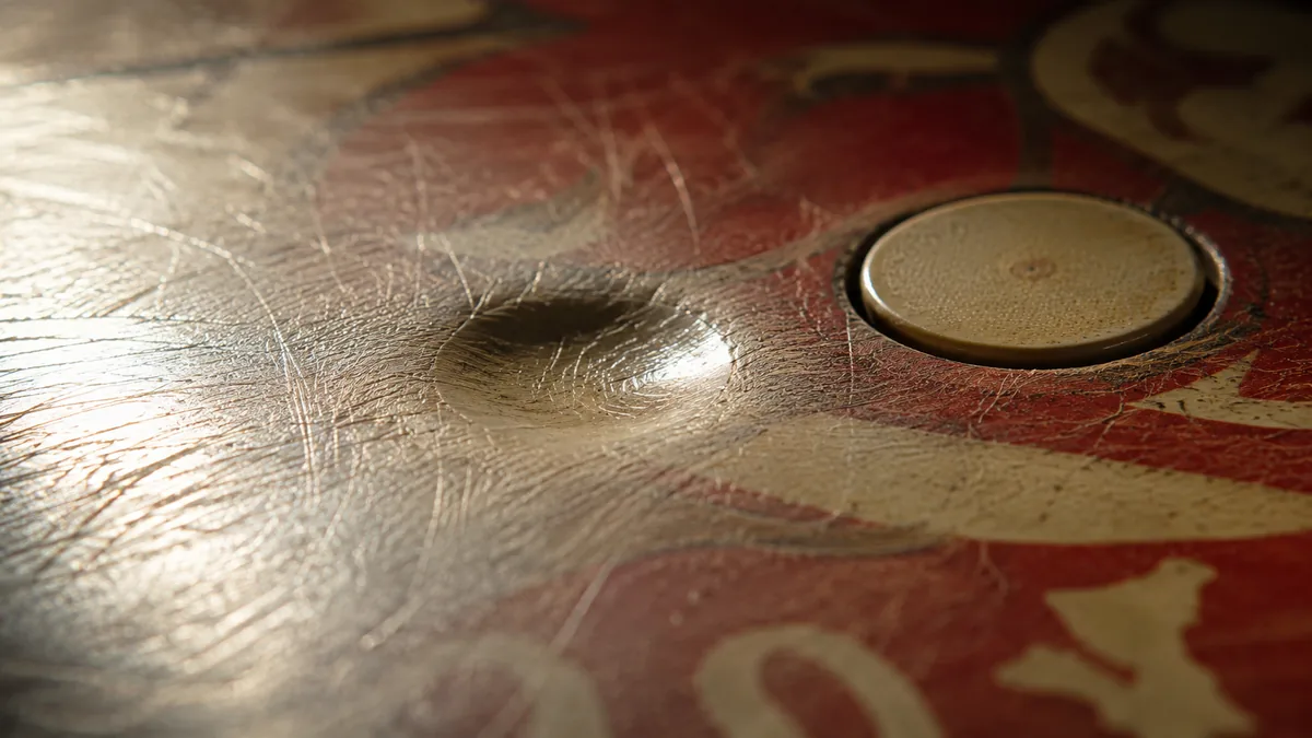 Close-up detail of vintage pinball hardware under game room lighting